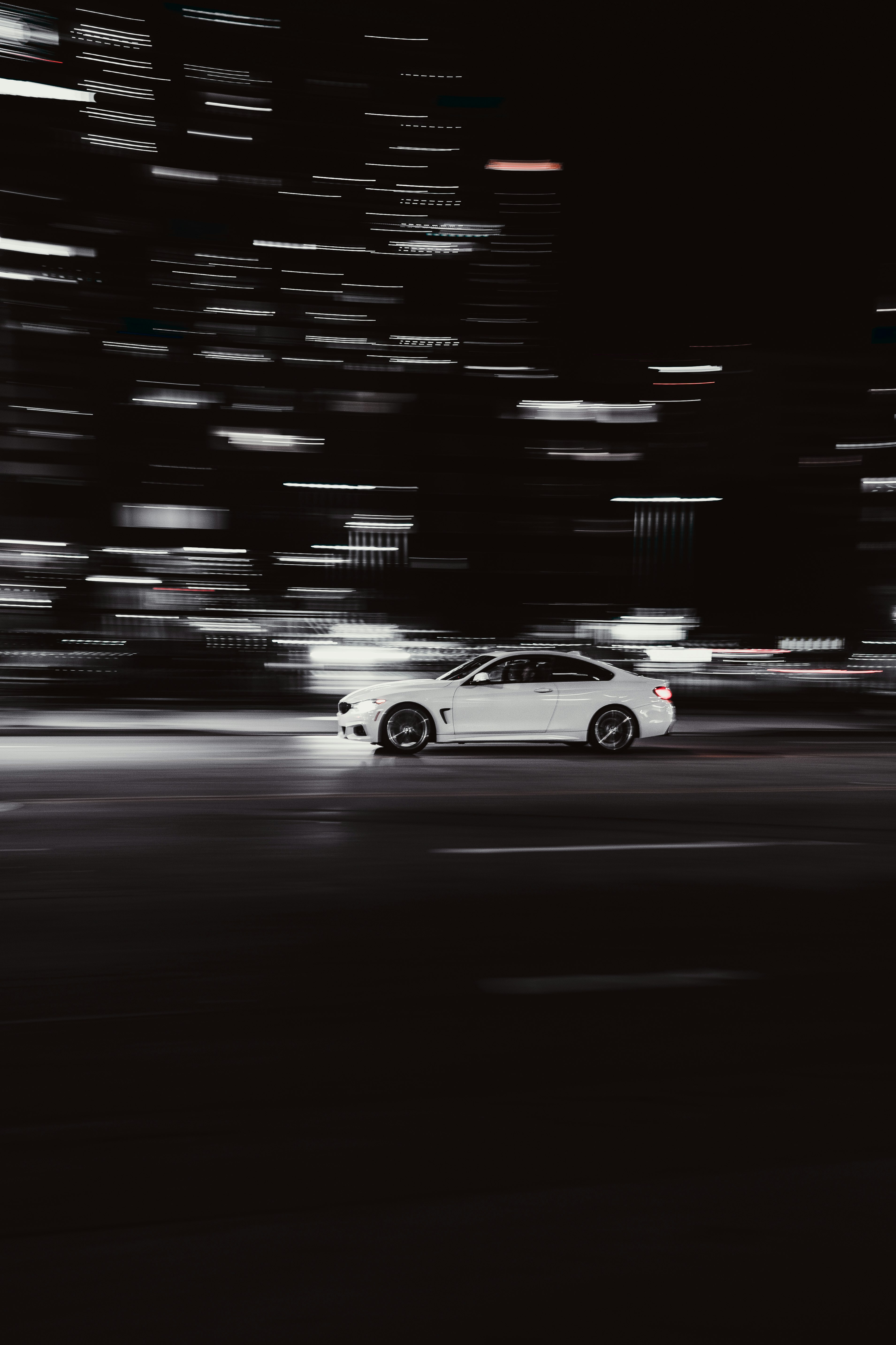 white coupe on road during night time